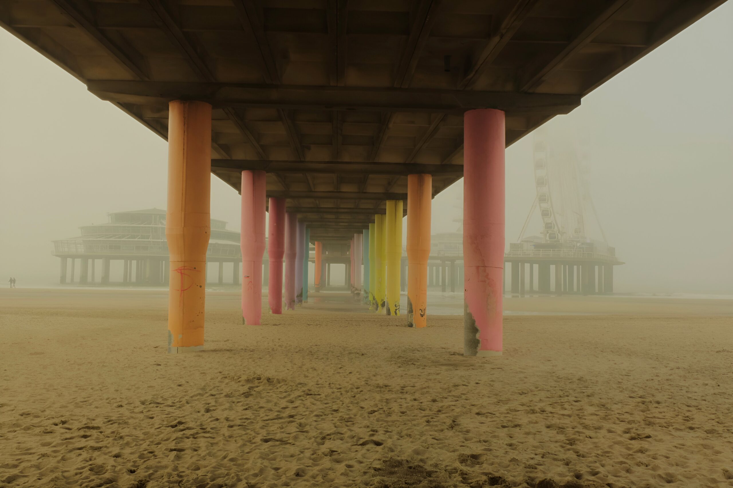 Colorful pillars under a bridge.