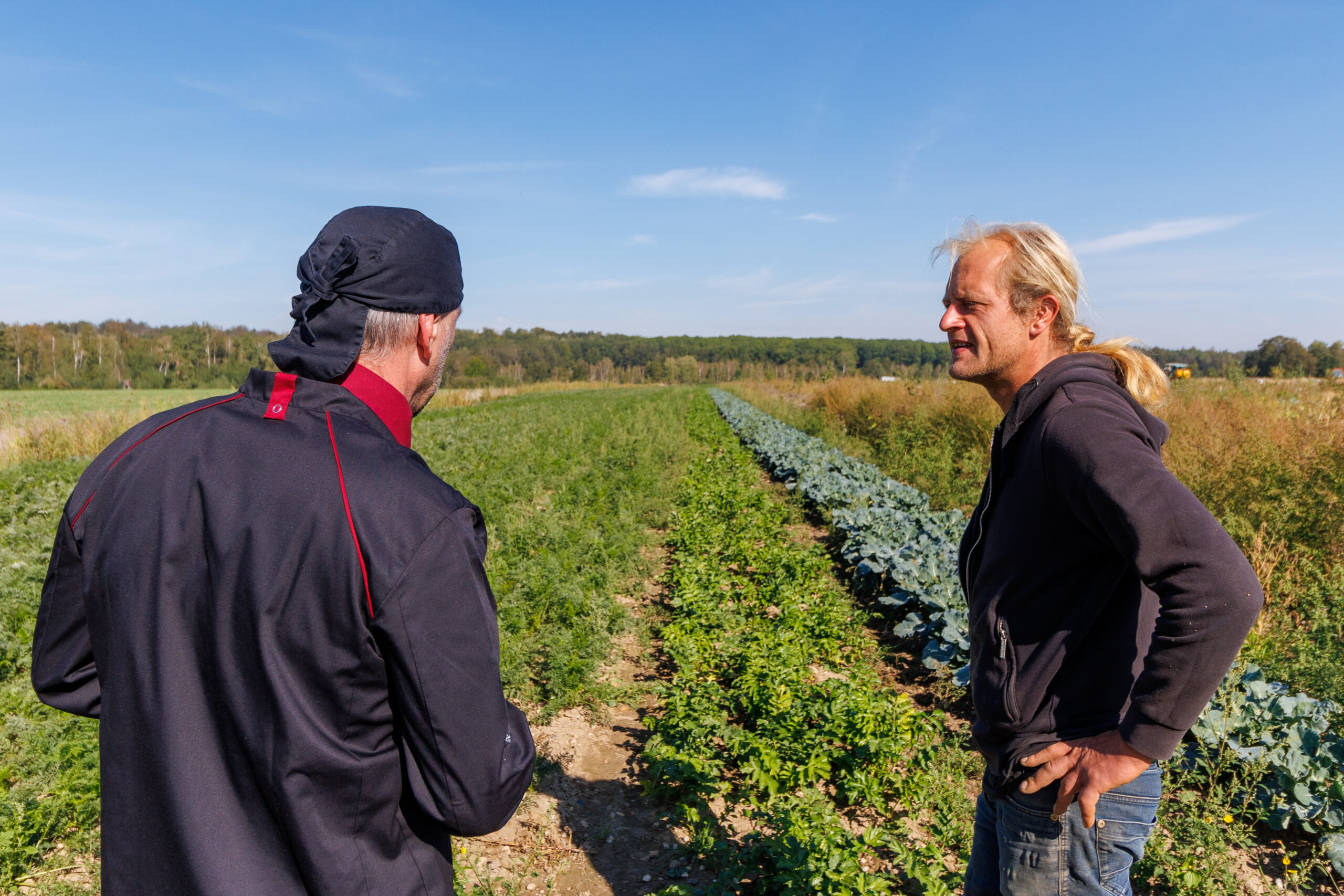 Two men are standing on a field.